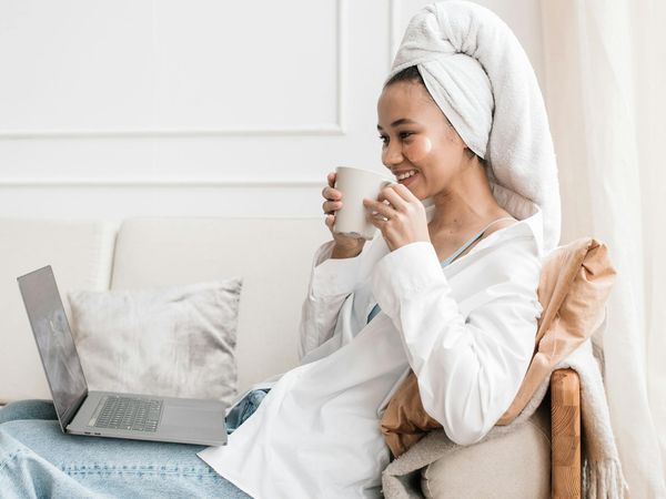 A person looking at their daily schedule with a cup of tea.