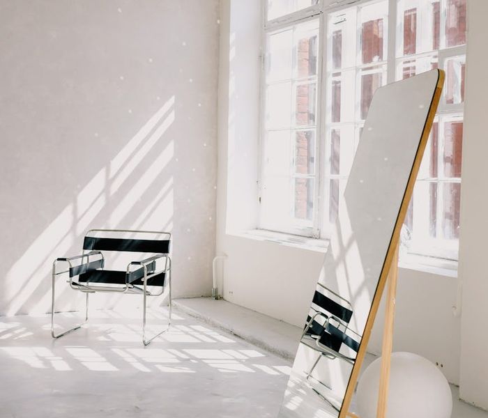 Person stretching peacefully in a bright, modern living room space.